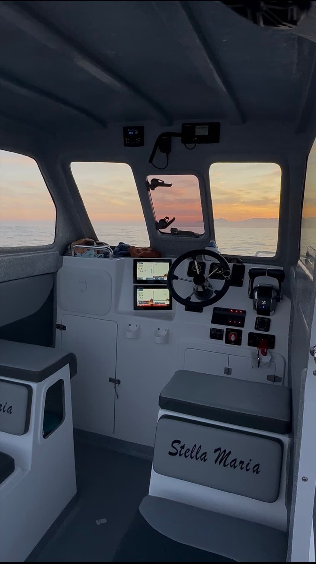The helm and cabin interior at sunrise